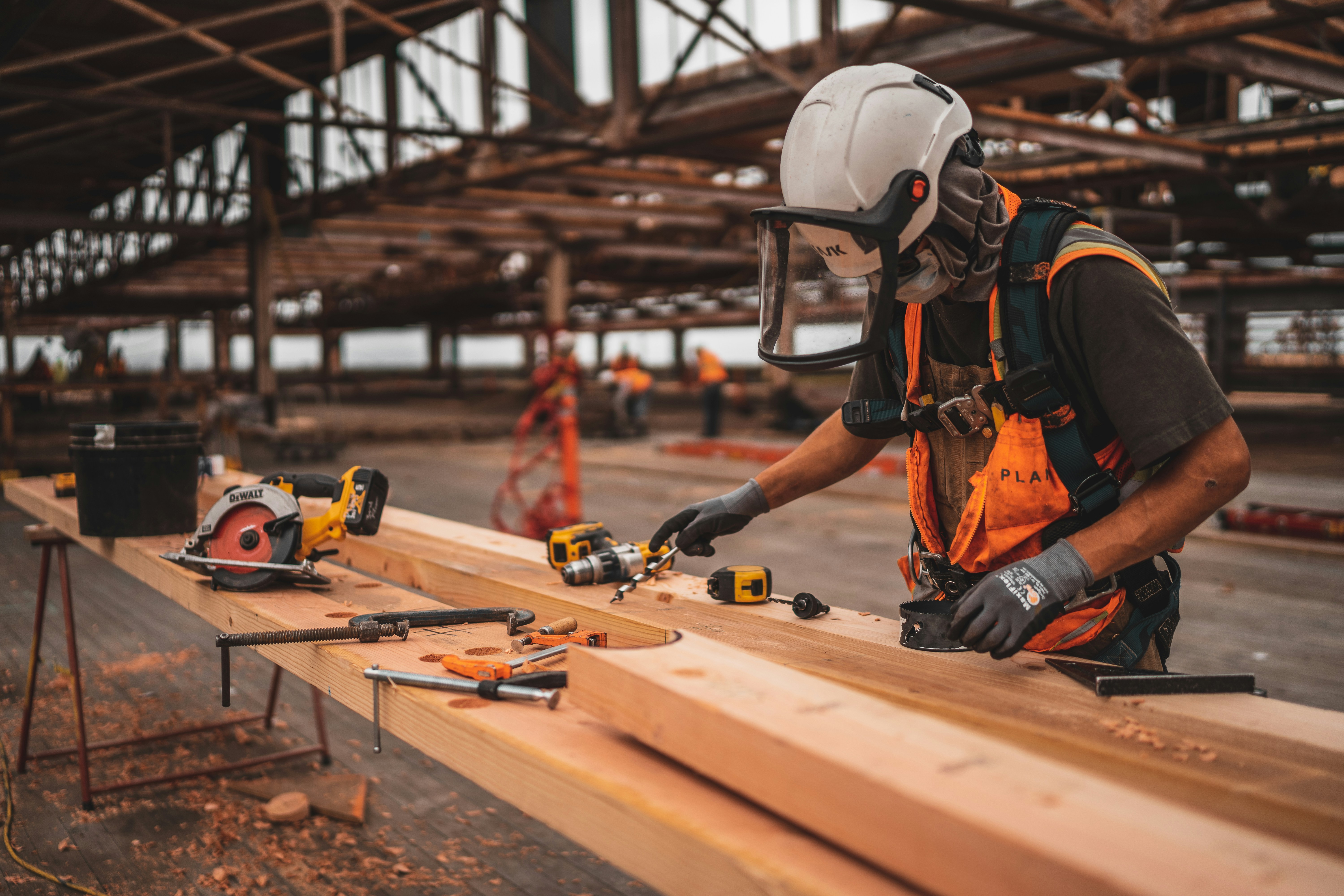 Civil construction crew fabricating structural timber on site
